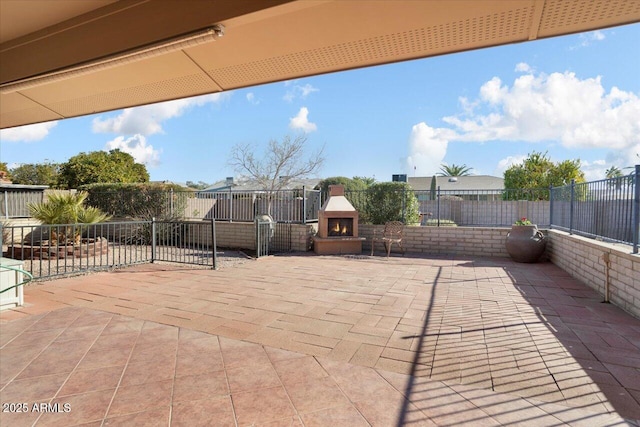 view of patio featuring an outdoor fireplace