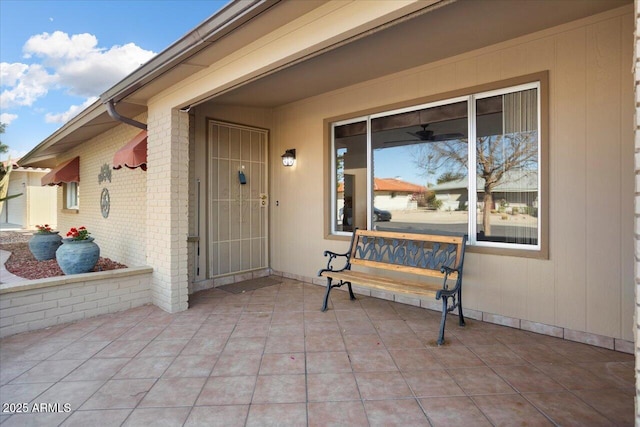 view of exterior entry with a patio