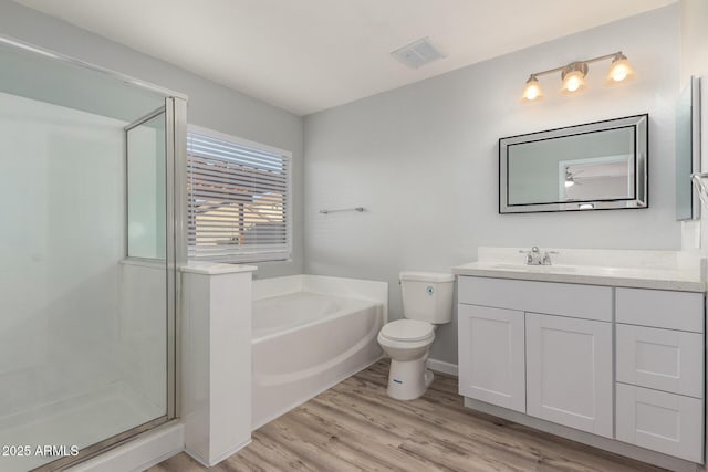 full bathroom with wood-type flooring, toilet, vanity, and plus walk in shower