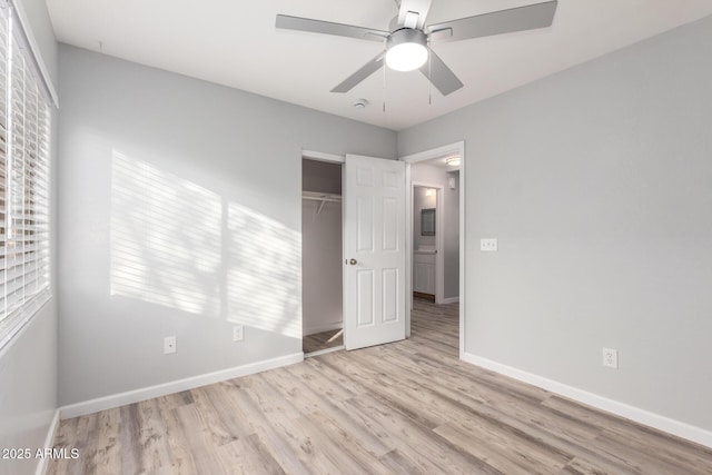 unfurnished bedroom featuring ceiling fan, light wood-type flooring, and a closet