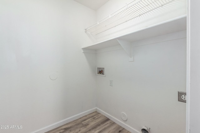 washroom featuring hookup for a gas dryer, electric dryer hookup, washer hookup, and light wood-type flooring