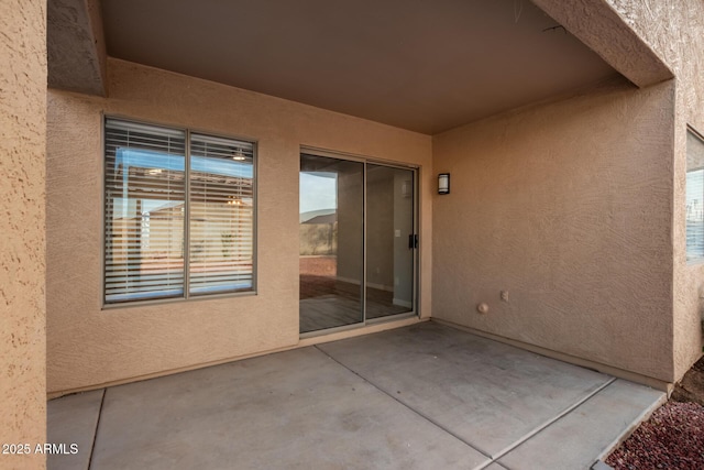 property entrance featuring a patio area