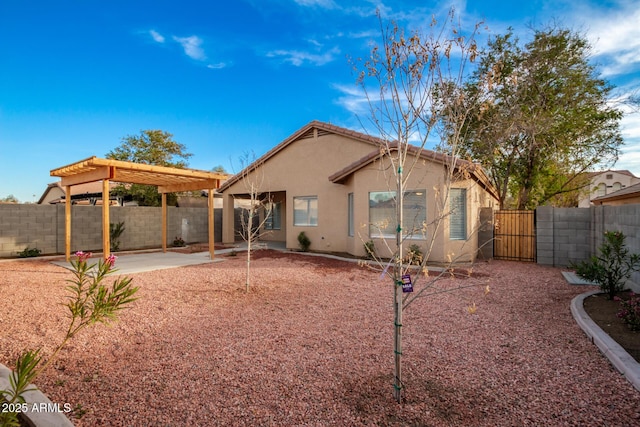 back of house featuring a pergola and a patio area