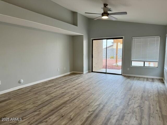 spare room featuring hardwood / wood-style flooring, ceiling fan, and lofted ceiling