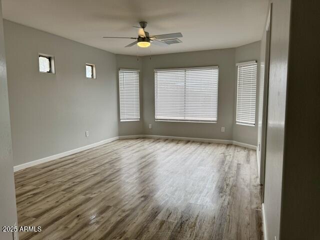 empty room featuring ceiling fan and wood-type flooring