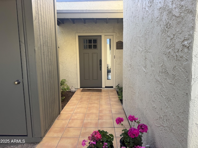 property entrance with stucco siding