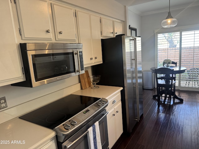 kitchen featuring crown molding, light countertops, stainless steel appliances, dark wood-style floors, and white cabinetry