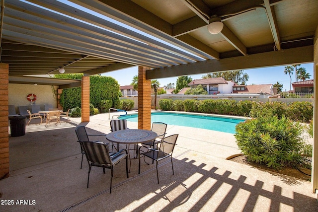 view of patio / terrace with outdoor dining area, a fenced in pool, and fence