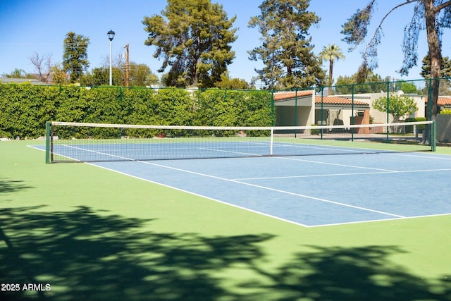 view of sport court featuring fence