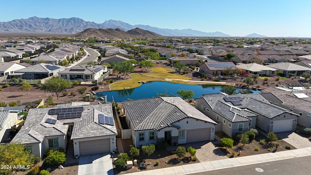 drone / aerial view featuring a water and mountain view