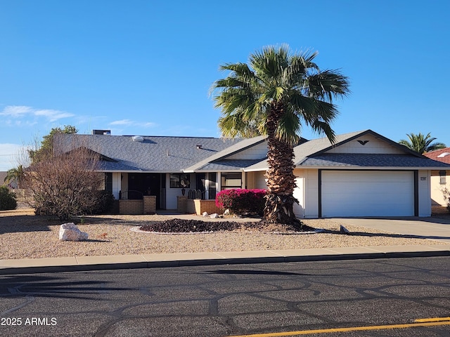 single story home featuring a garage and concrete driveway