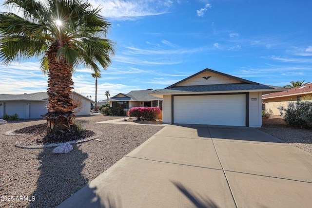 ranch-style home featuring concrete driveway and an attached garage