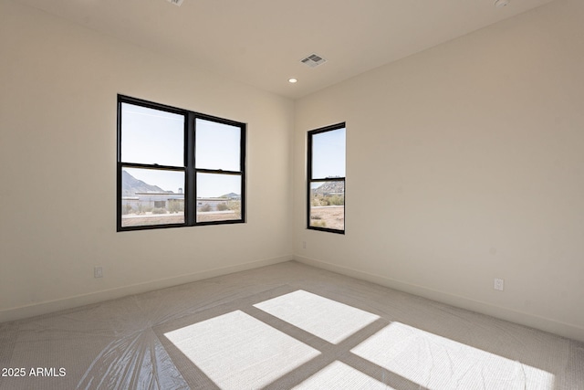 carpeted spare room with a mountain view