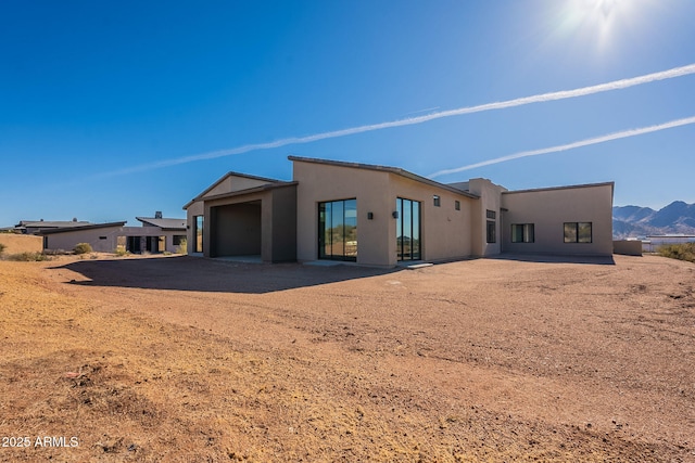 25572 N 119th St, Scottsdale, AZ 85255 - back of house with a garage, stucco siding, driveway, and a mountain view