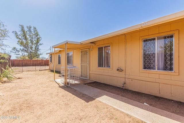 rear view of house with fence