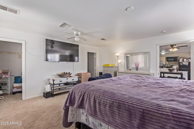 bedroom with carpet, visible vents, and a ceiling fan