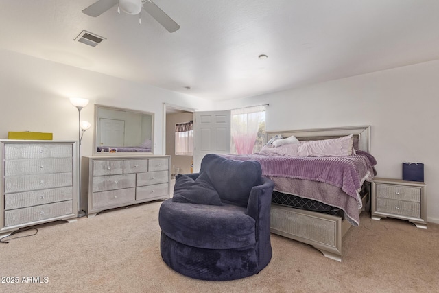 bedroom with connected bathroom, visible vents, ceiling fan, and carpet flooring