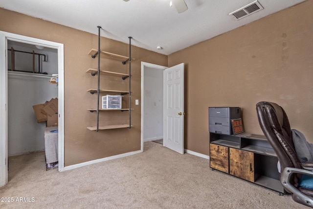 home office with carpet floors, visible vents, baseboards, and a ceiling fan