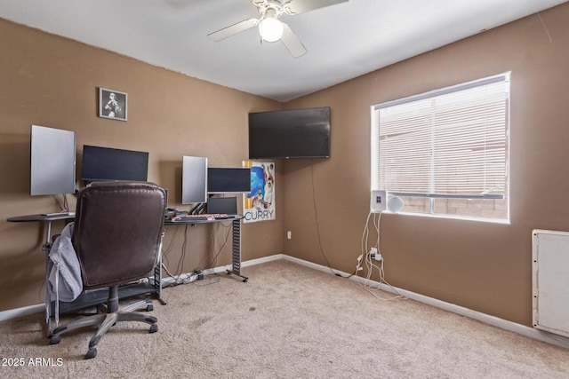 carpeted home office featuring baseboards and a ceiling fan