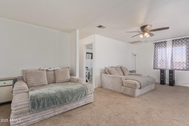 interior space with carpet, visible vents, and ceiling fan