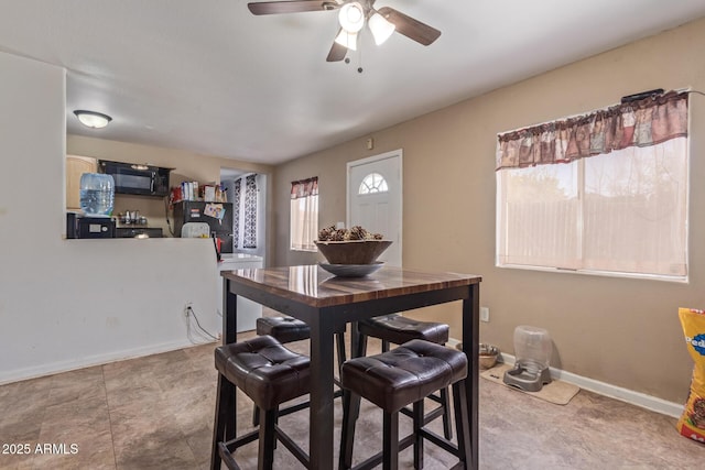 dining room with baseboards and a ceiling fan