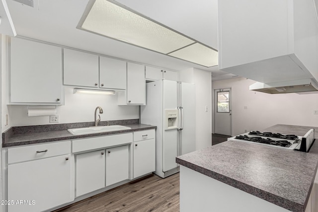 518 N Cheri Lynn Dr, Chandler, AZ 85225 - kitchen featuring a sink, white fridge with ice dispenser, dark countertops, light wood-style flooring, and white cabinets