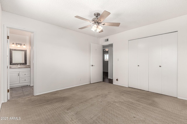 518 N Cheri Lynn Dr, Chandler, AZ 85225 - unfurnished bedroom featuring carpet floors, a closet, ensuite bath, a textured ceiling, and a sink