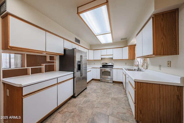 12611 N 112th Ave, Youngtown, AZ 85363 - kitchen featuring stainless steel appliances, a sink, under cabinet range hood, and white cabinetry