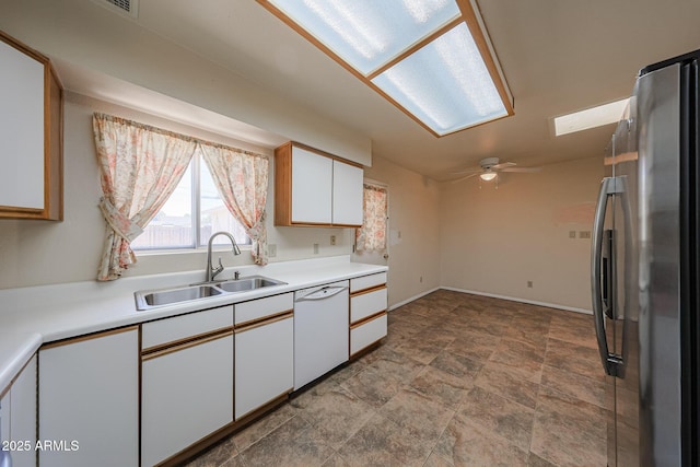 12611 N 112th Ave, Youngtown, AZ 85363 - kitchen featuring white dishwasher, freestanding refrigerator, a sink, white cabinetry, and light countertops