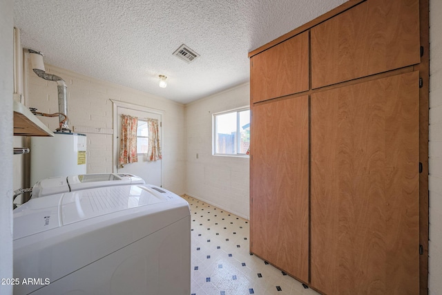 12611 N 112th Ave, Youngtown, AZ 85363 - laundry room with cabinet space, separate washer and dryer, light flooring, a textured ceiling, and water heater