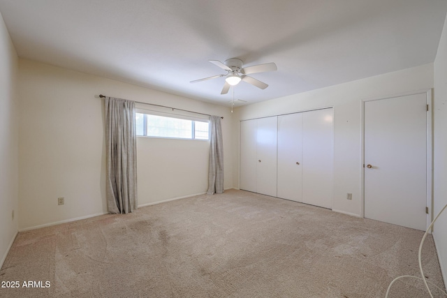 12611 N 112th Ave, Youngtown, AZ 85363 - unfurnished bedroom with light carpet, ceiling fan, and a closet
