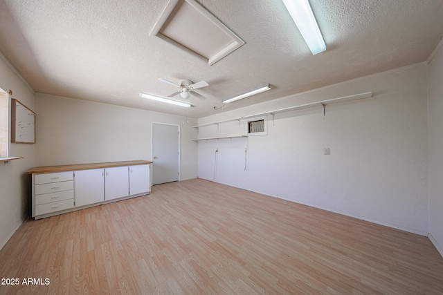 12611 N 112th Ave, Youngtown, AZ 85363 - spare room with a textured ceiling, attic access, and light wood-type flooring