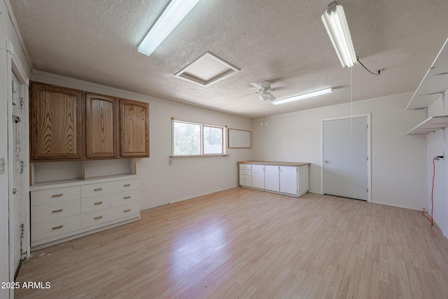 12611 N 112th Ave, Youngtown, AZ 85363 - empty room featuring a textured ceiling, light wood finished floors, ceiling fan, and attic access