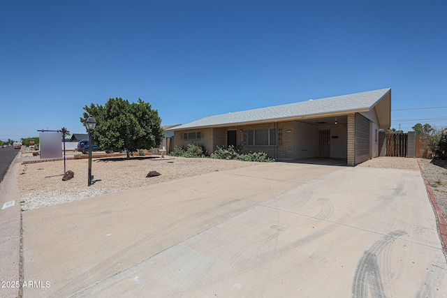 12611 N 112th Ave, Youngtown, AZ 85363 - single story home with driveway, a carport, and brick siding