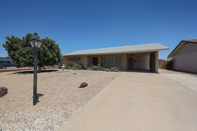 12611 N 112th Ave, Youngtown, AZ 85363 - single story home with driveway, brick siding, and a carport