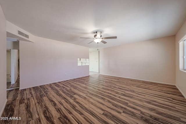 12611 N 112th Ave, Youngtown, AZ 85363 - unfurnished room featuring dark wood finished floors, ceiling fan, and baseboards