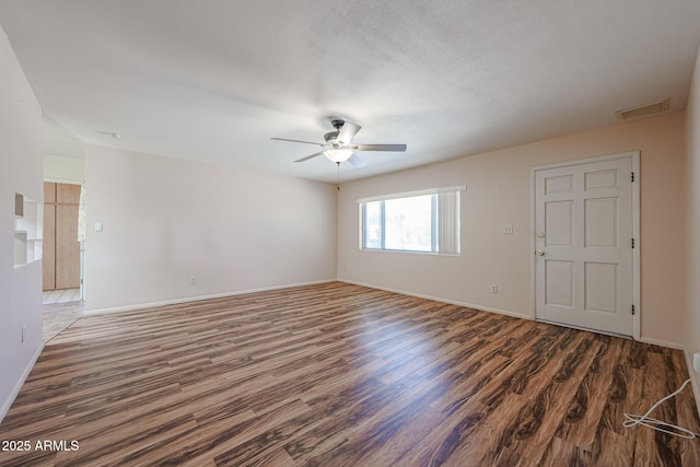 12611 N 112th Ave, Youngtown, AZ 85363 - unfurnished room featuring wood finished floors, a ceiling fan, and baseboards