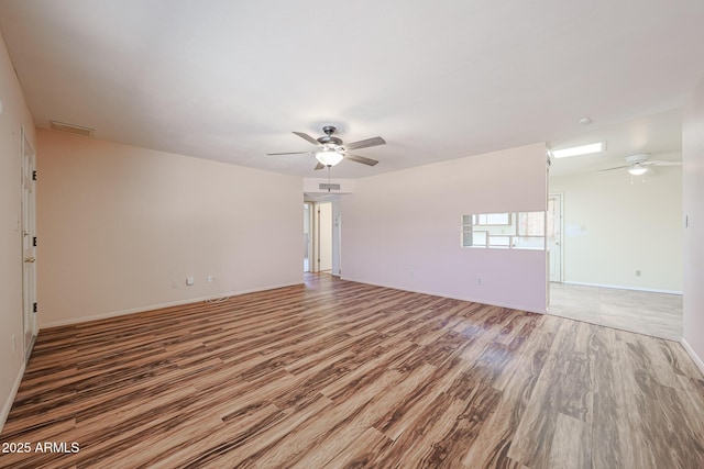 12611 N 112th Ave, Youngtown, AZ 85363 - empty room with a ceiling fan, light wood-style floors, and baseboards