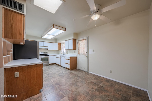 12611 N 112th Ave, Youngtown, AZ 85363 - kitchen featuring stainless steel appliances, under cabinet range hood, ceiling fan, baseboards, and light countertops