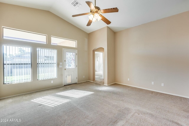 carpeted spare room with ceiling fan and high vaulted ceiling