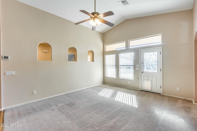 spare room featuring light carpet, high vaulted ceiling, and ceiling fan