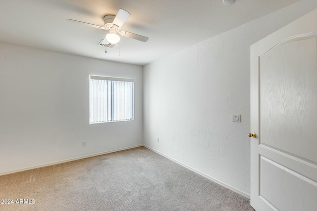 unfurnished room with ceiling fan and light carpet