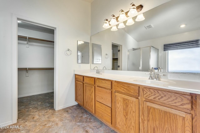 bathroom with vanity and a shower with shower door