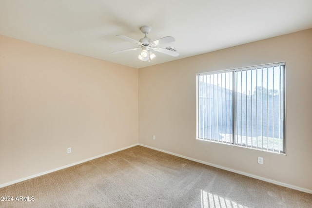 unfurnished room with carpet, ceiling fan, and a healthy amount of sunlight