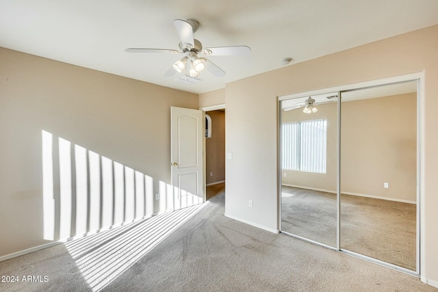 unfurnished bedroom featuring carpet flooring, ceiling fan, and a closet