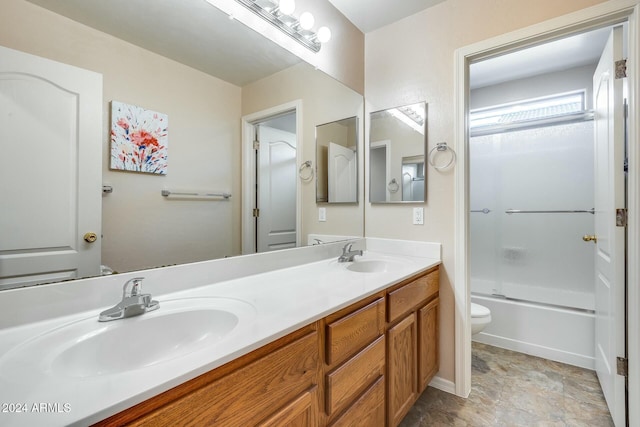 full bathroom featuring combined bath / shower with glass door, vanity, and toilet