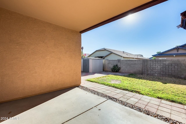 view of patio featuring a shed