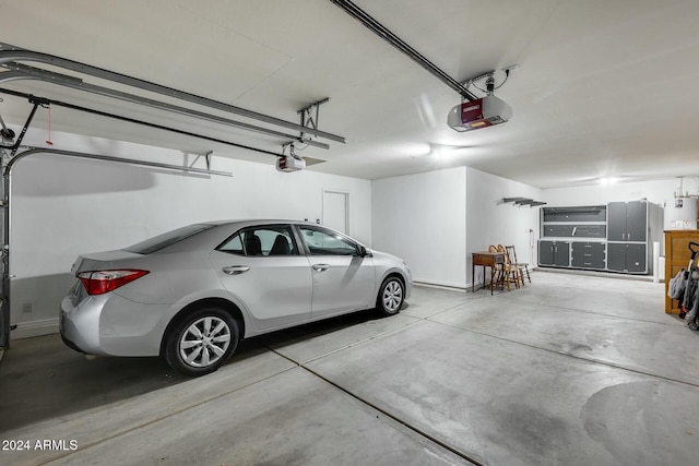 garage with a garage door opener and water heater