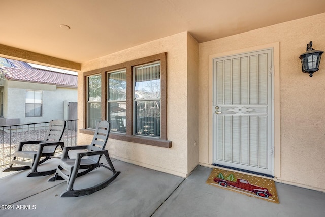 entrance to property featuring covered porch