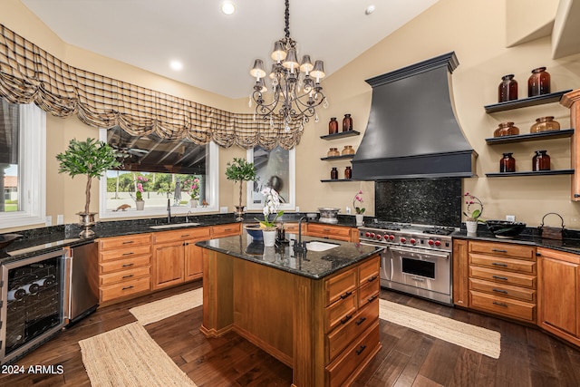 kitchen with beverage cooler, custom range hood, dark hardwood / wood-style floors, appliances with stainless steel finishes, and a center island